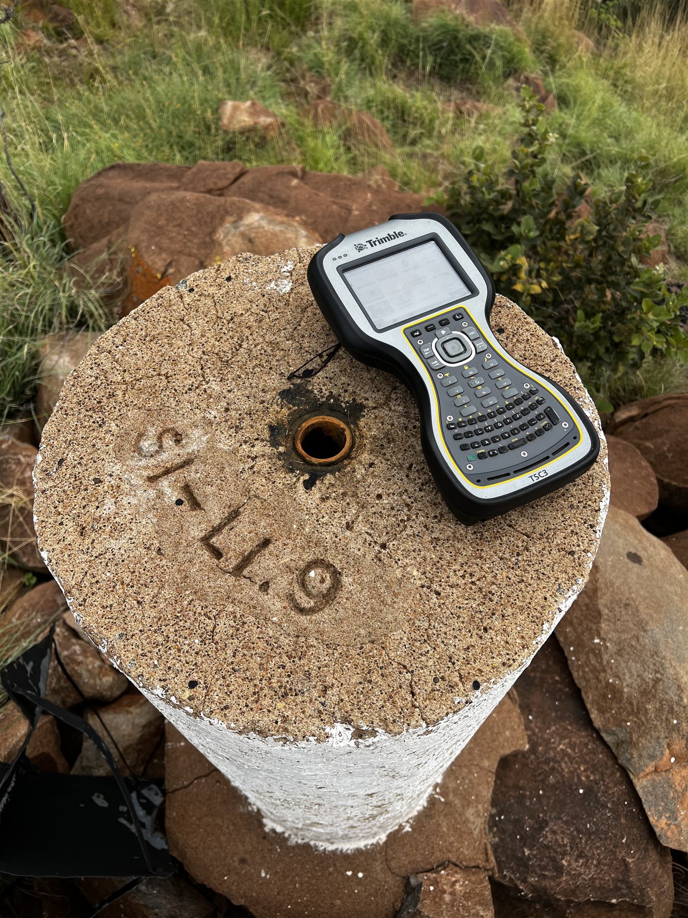 Survey field controller resting on a permanent control pillar